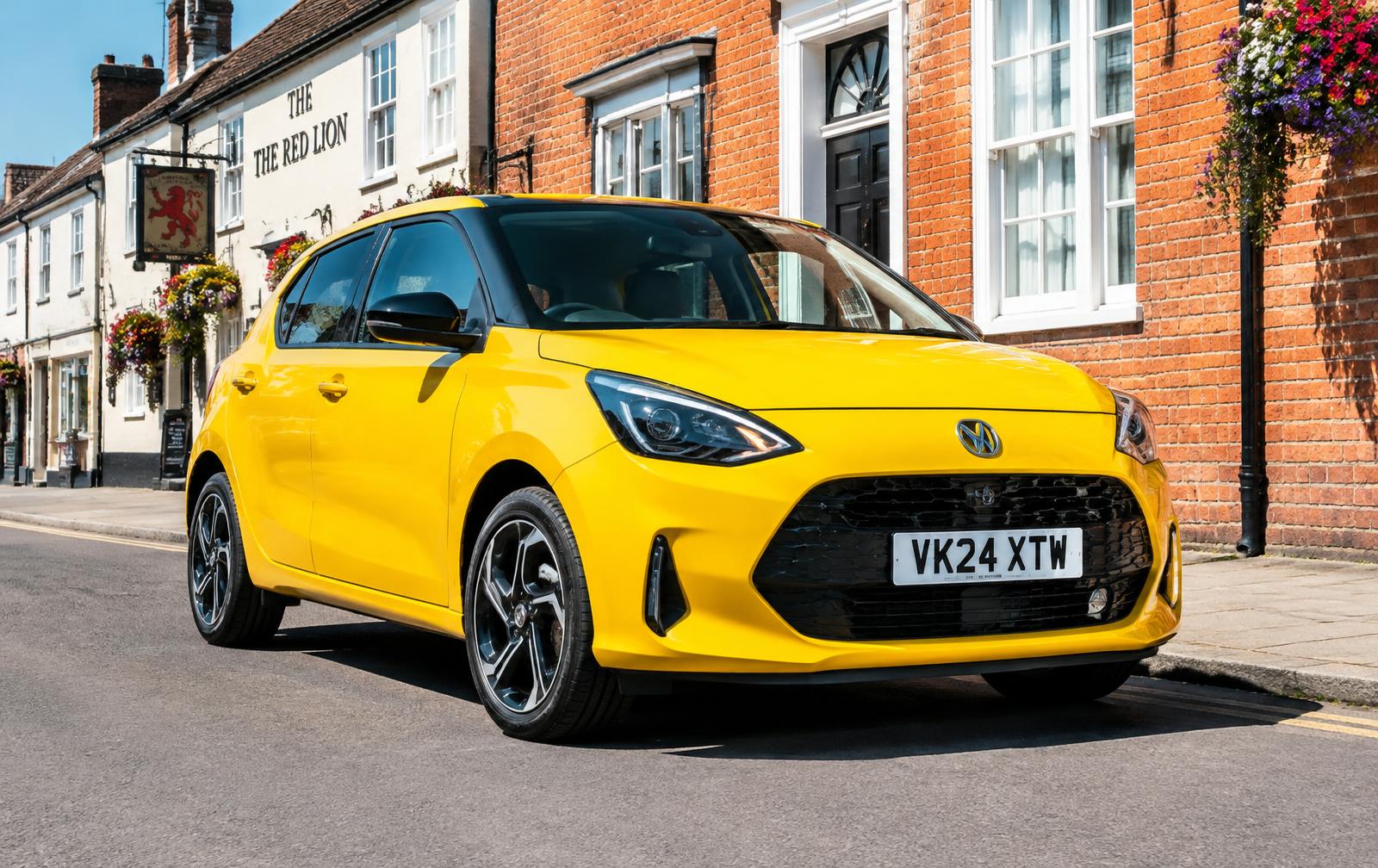 Yellow hatchback parked on a British high street
